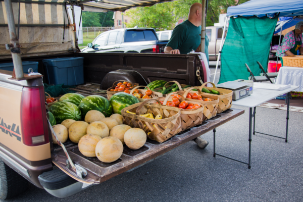 produce in the back of a truck at the local farmers market