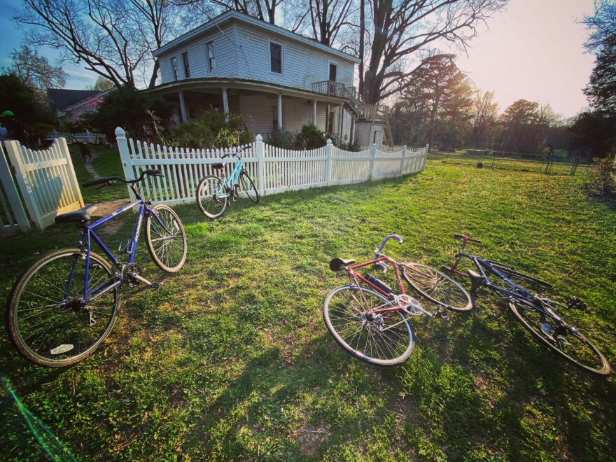 Bikes scattered on the lawn of an older home in Warrenton